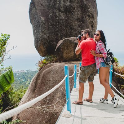 young happy hipster couple in love traveling around world, sightseeing, tropical romantic vacation in thailand, taking pictures on digital photo camera, active tourism, summer